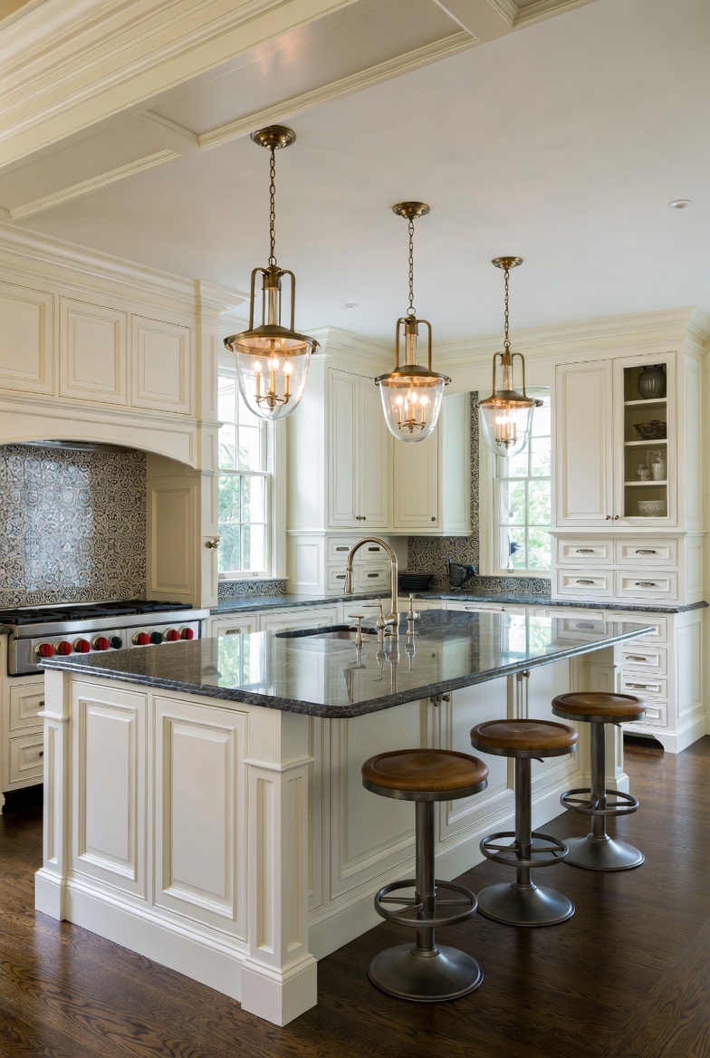 Whole-home kitchen renovation — custom millwork, granite island, hand-blown glass pendants, dark hardwood